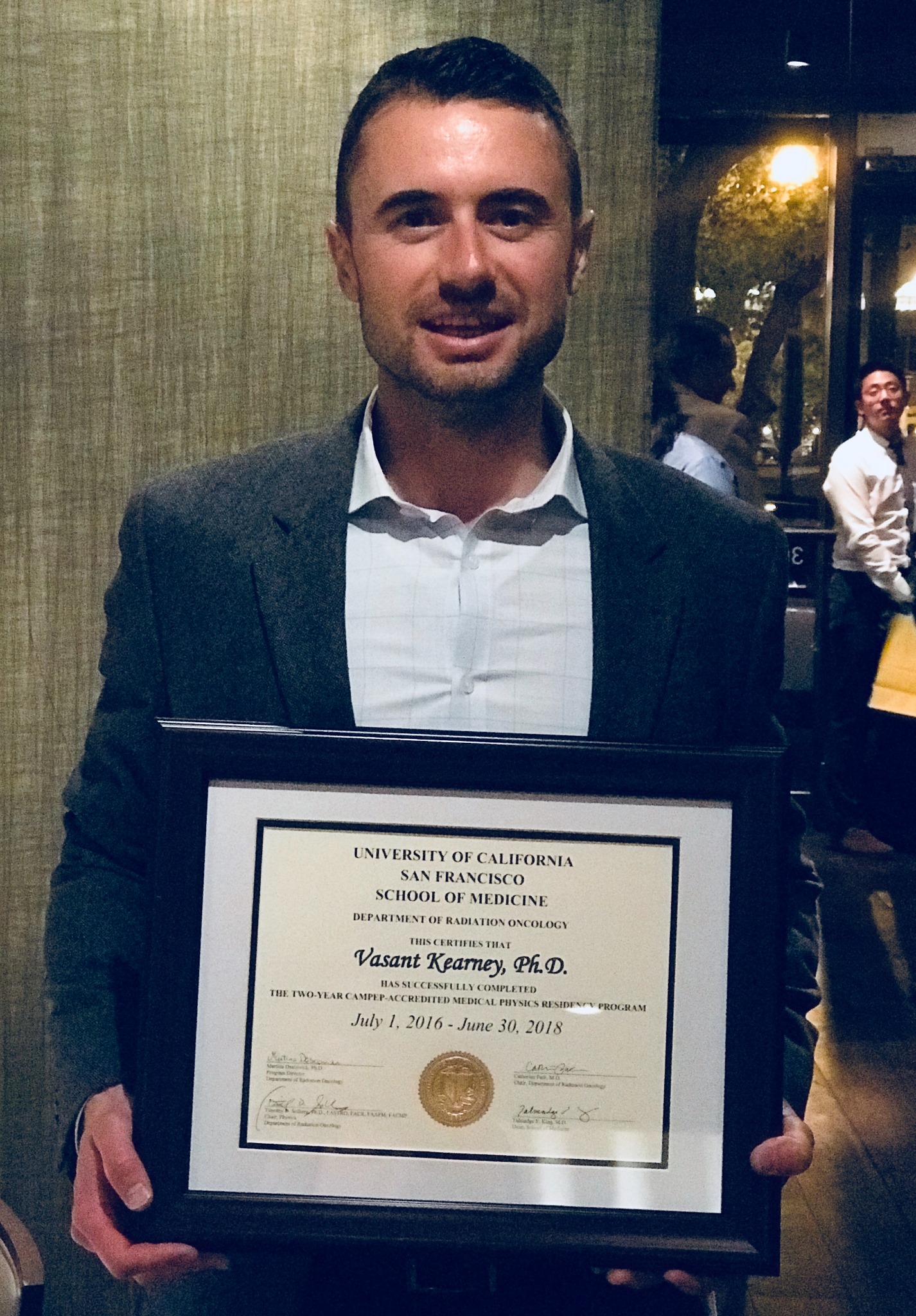 Vasant Kearney holding the UCSF medical physics residency certificate